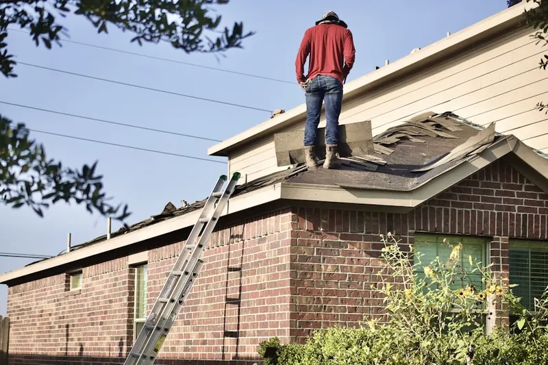 Professional roofer working on a residential roof in Apache Wells